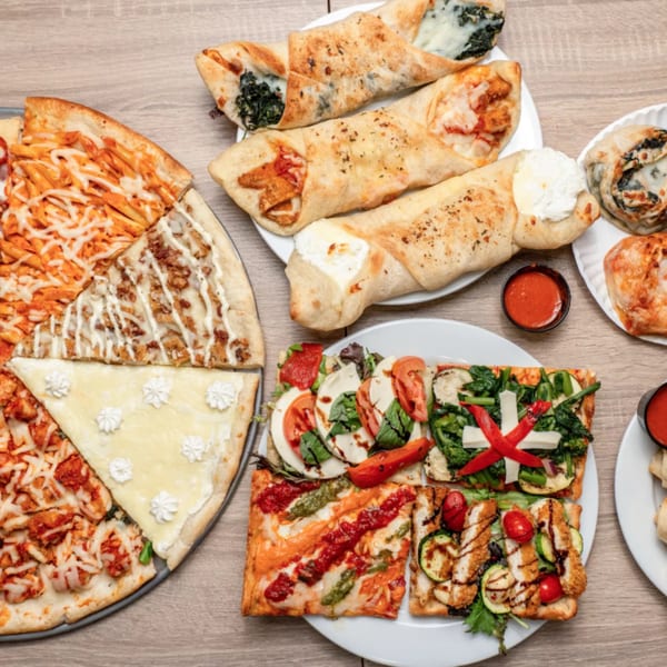 An overhead shot of Angelo's Pizzeria's diverse offerings, including pizzas, calzones, and focaccia.